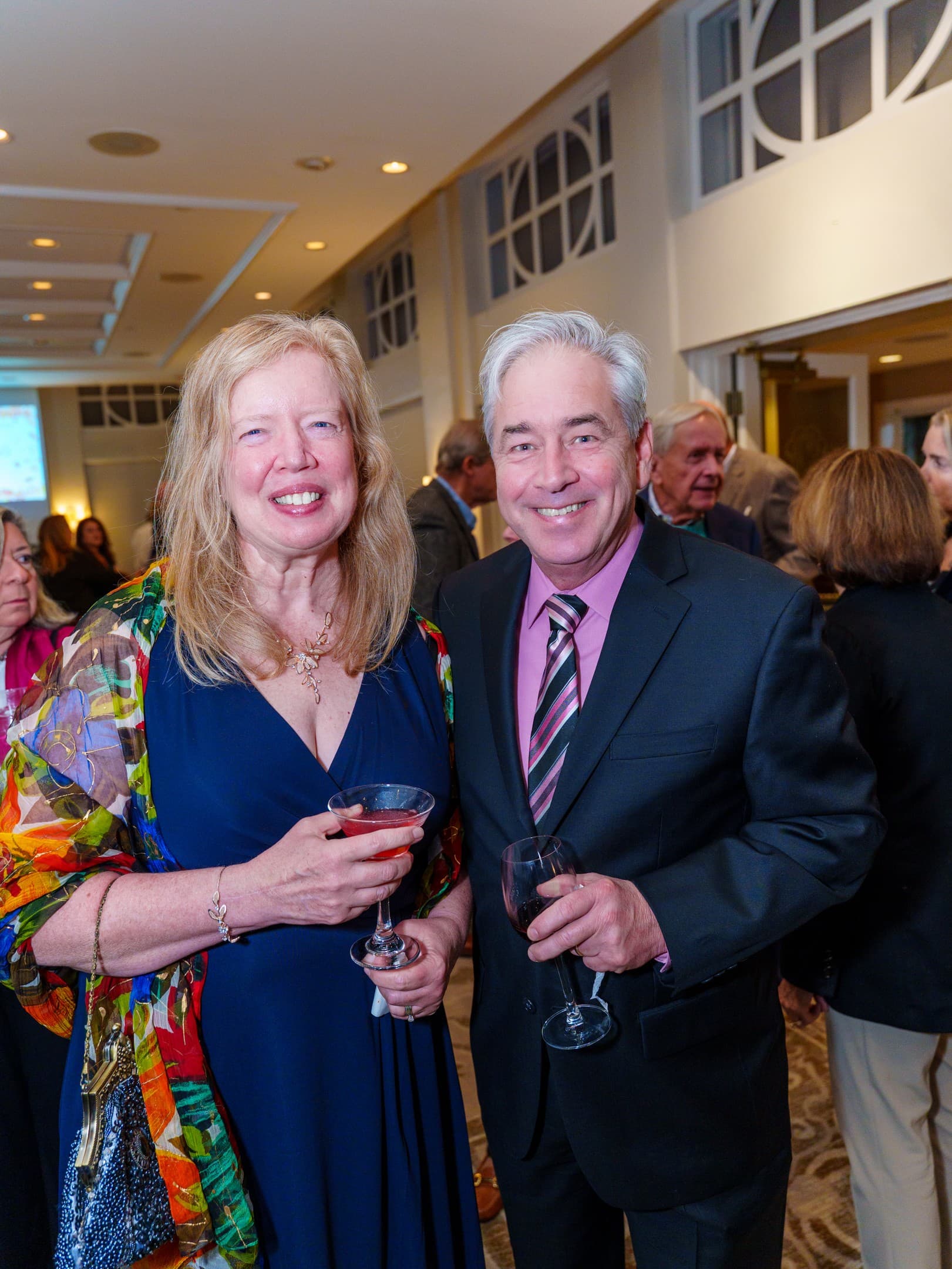 Guests smiling together at golden hour during a benefit event