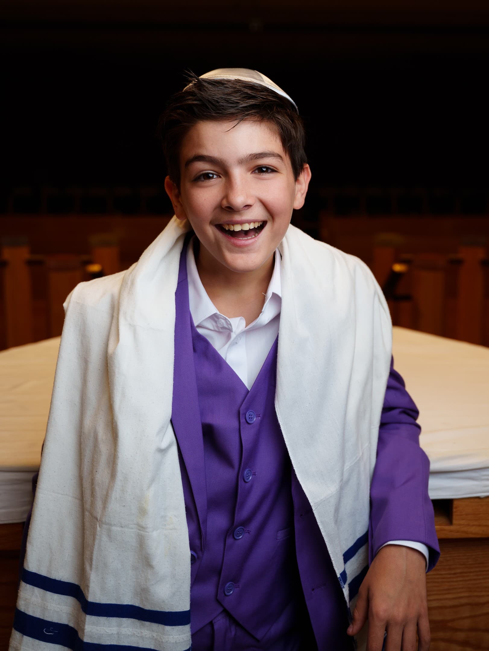 Bar mitzvah portrait, boy laughing in a purple vest