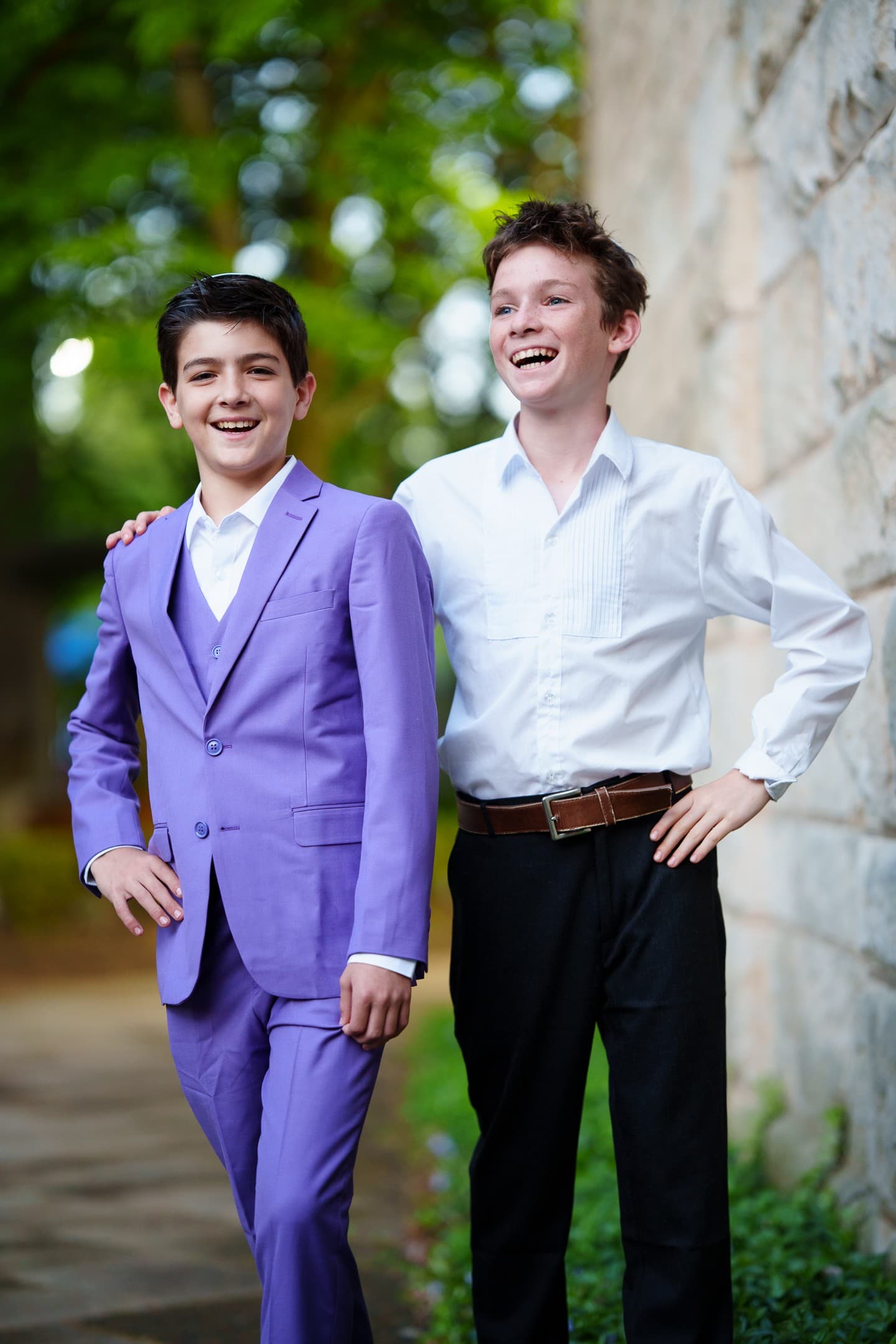 Two friends laughing together at a bar mitzvah