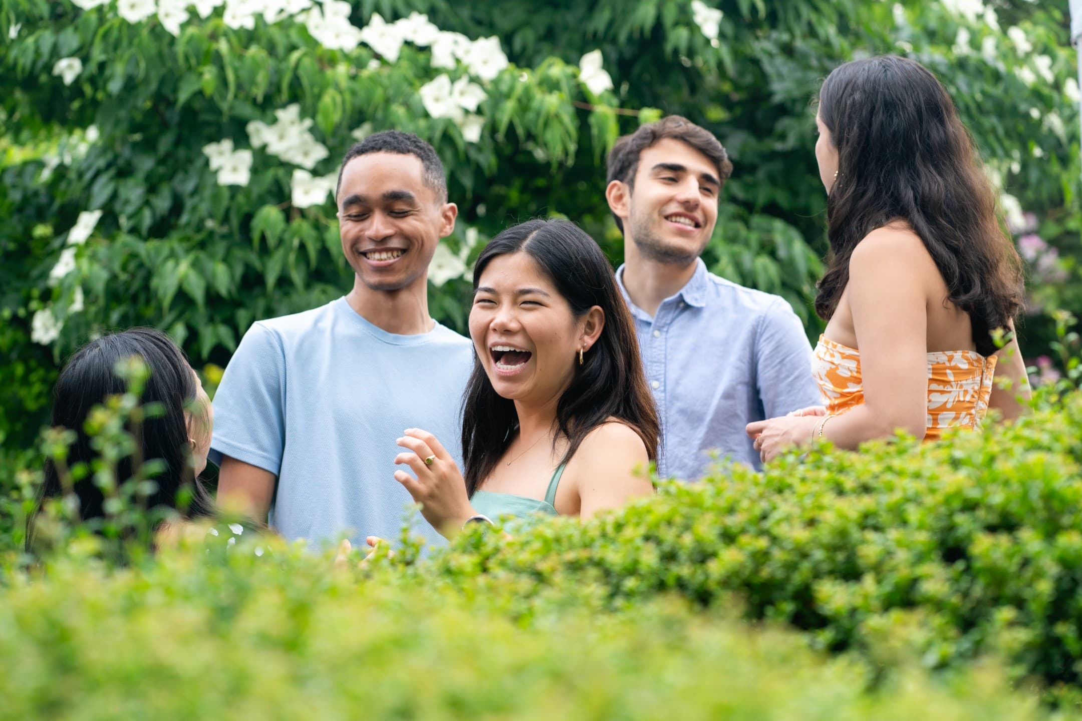 Friends laughing candidly at an outdoor private party